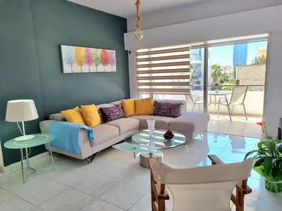 a living room with a couch and a table at Ikaros Boutique Apartment in Limassol