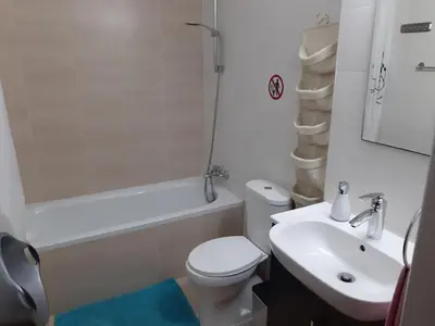a bathroom with a toilet and a sink and a bath tub at Mythical Sands Resort Ilona Apartment for families in Protaras