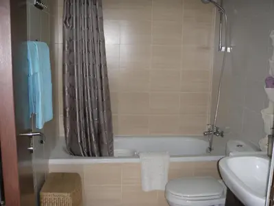 a bathroom with a tub and a toilet and a sink at Mythical Sands Resort Ilona Apartment for families in Protaras