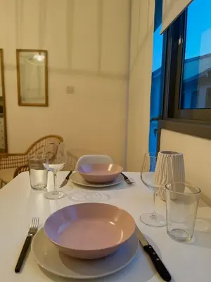 a table with plates and bowls and glasses on it at RHEA Studio Down Town Nicosia in Nicosia