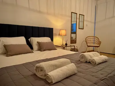 a bedroom with a large bed with towels on it at RHEA Studio Down Town Nicosia in Nicosia