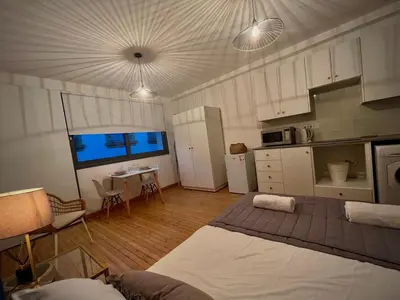 a kitchen with two beds and a table in it at RHEA Studio Down Town Nicosia in Nicosia