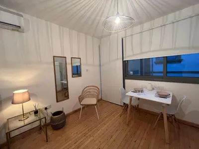 a white room with a table and chairs and a window at RHEA Studio Down Town Nicosia in Nicosia