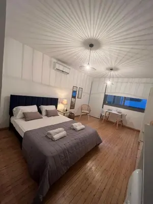 a bedroom with a large bed with two towels on it at RHEA Studio Down Town Nicosia in Nicosia