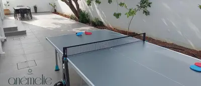 a ping pong table sitting on a patio at anemelie in Sotira