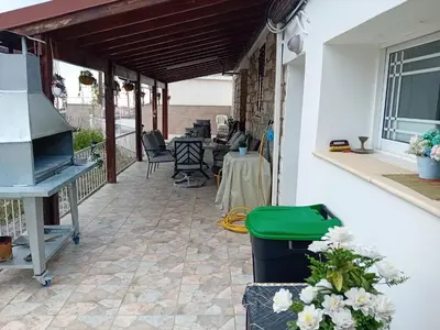 a patio with a grill and a table and chairs at Traditional house in pelendri in Limassol