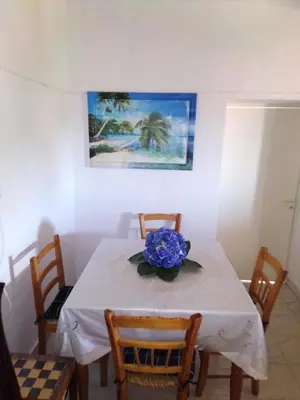 a dining room table with a blue flower on it at Traditional house in pelendri in Limassol
