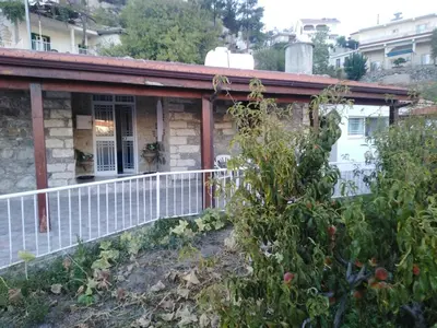 a house with a white fence in the yard at Traditional house in pelendri in Limassol