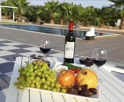 a table with a plate of fruit and wine glasses at The Pervoli Studio - Pool - Close to Beach in Larnaka