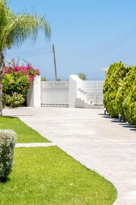 a walkway in a yard with plants and flowers at Villa Amelia by Ezoria Villas in Pervolia