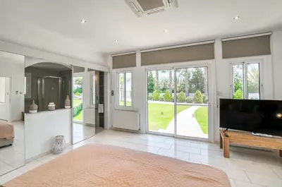 a large living room with a television and a couch at Villa Amelia by Ezoria Villas in Pervolia