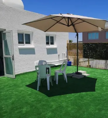 a table and two chairs under an umbrella at Kalidonia “PANORAMA” STUDIO APARTMENT in Engomi