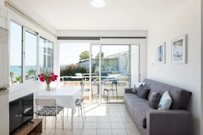 a living room with a couch and a table at Oceanview Apartment in Larnaka