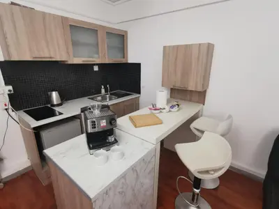 a kitchen with a counter with a sewing machine on it at Adorable Cozy Apartment in Aglantzia