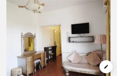 a living room with a couch and a desk and a mirror at St Elena Boutique Residence in Larnaka