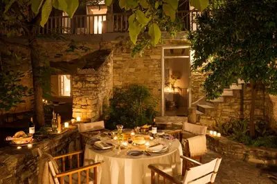 a table set for a meal in a garden at night at Ample Places in Pano Lefkara