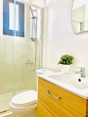 a bathroom with a sink and a toilet and a shower at BALI SUITES 101 in Larnaka