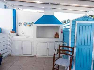 a bathroom with a sink and a blue shed at Greek Island Style 2 bedroom Villa with Pool next to the Sea in Larnaka