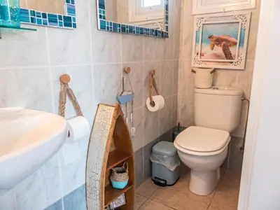 a bathroom with a toilet and a sink at Greek Island Style 2 bedroom Villa with Pool next to the Sea in Larnaka