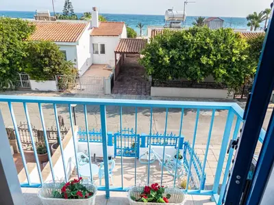 a balcony with chairs and a view of the ocean at Greek Island Style 2 bedroom Villa with Pool next to the Sea in Larnaka