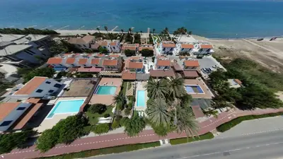 arial view of a villa with palm trees and the ocean at Greek Island Style 2 bedroom Villa with Pool next to the Sea in Larnaka