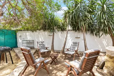 a group of chairs and a table and trees at To Hani - Large Traditional House in Nicosia
