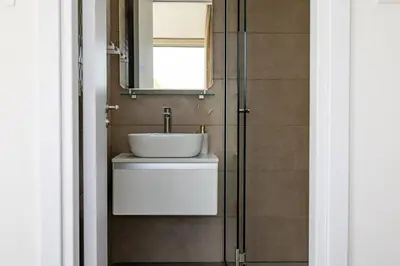 a bathroom with a sink and a mirror at Villa Pacy in Ayios Theodhoros