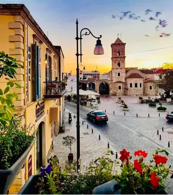 a view of a street with a church and a car at BALI SUITES 505 in Larnaka