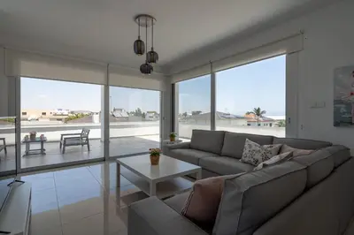 a living room with a couch and a table at Harmonia 2-BR Apt in Livadia in Larnaka