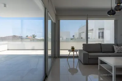 a living room with a couch and a table at Harmonia 2-BR Apt in Livadia in Larnaka