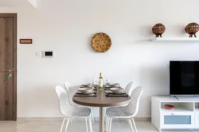 a dining room with a table and chairs at Bonne Heure 1-BR Apt in Larnaca in Larnaka