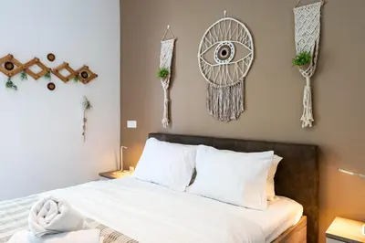 a bedroom with a bed and some decorations on the wall at Bonne Heure 1-BR Apt in Larnaca in Larnaka