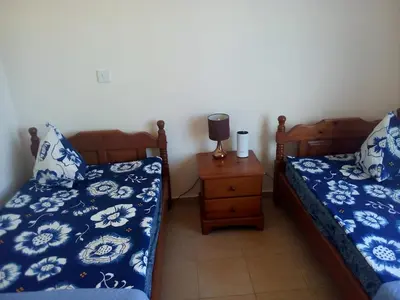 a bedroom with two twin beds and a night stand at Summer Breeze - Cheerful 2 bedroom villa with pool in Ayia Napa