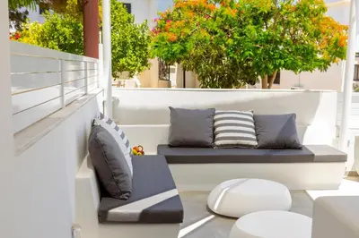 a balcony with pillows and a bench on a balcony at Protaras Rose By The Sea Villa in Protaras