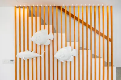 a staircase with three white fish sculptures on it at Protaras Rose By The Sea Villa in Protaras