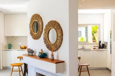 a kitchen with two mirrors on the wall at Protaras Rose By The Sea Villa in Protaras