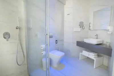 a bathroom with a shower and a toilet and a sink at MARGADINA HOTEL in Ayia Napa