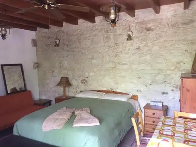 a bedroom with a bed with towels on it at AYIOS NICOLAOS RIVER PARK in Perapedhi