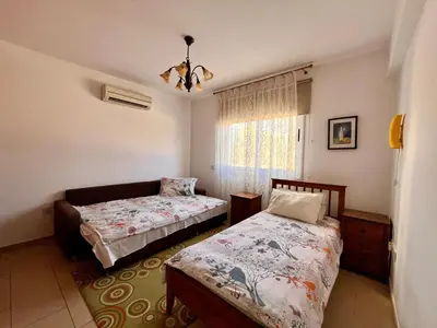 a bedroom with two beds and a window at 2 bedroom with private garden, walk to Nissi Beach, communal swimming pool in Ayia Napa