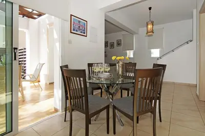 a dining room with a glass table and chairs at Villa Danata in Protaras