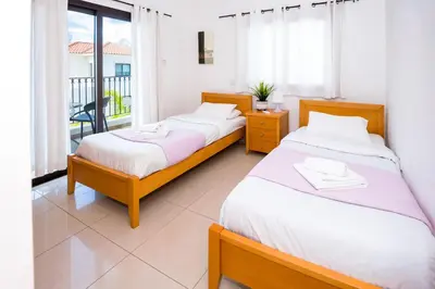 two beds in a room with a balcony at Villa Abdera - 4bed with Private Pool in Protaras