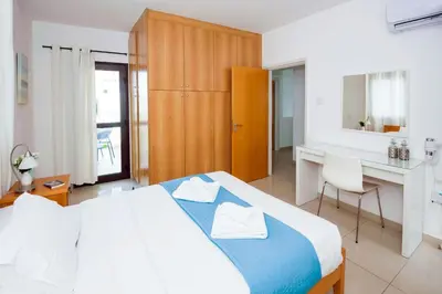 a hotel room with a bed and a desk and a desk at Villa Abdera - 4bed with Private Pool in Protaras