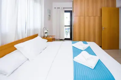 a bedroom with a white bed with two towels on it at Villa Abdera - 4bed with Private Pool in Protaras