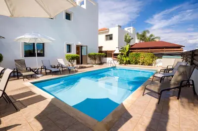 a swimming pool in front of a house at Villa Abdera - 4bed with Private Pool in Protaras