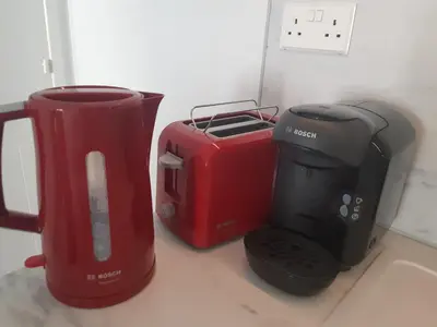 two toasters and a coffee maker on a counter at Beautiful apartment near beach in Larnaca in Scala