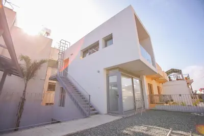 a white house with a staircase on it at St. Lazaros Studios in Larnaka