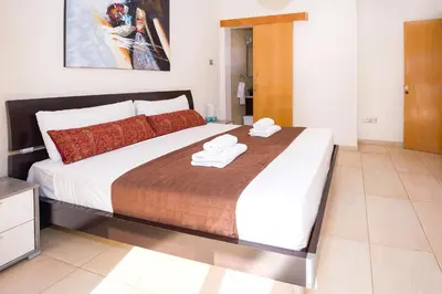 a bedroom with a large bed with towels on it at Villa Emily in Protaras
