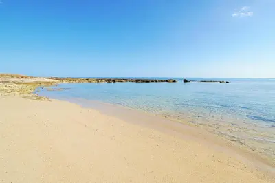 a sandy beach with the ocean in the background at Villa Louisa in Ayia Napa