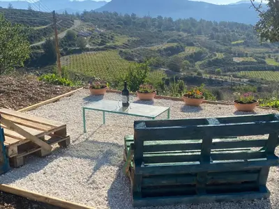 a table and bench with a view of a valley at House on a Hill with Stunning Views near Troodos in Silikou