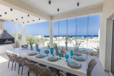 a dining room with a white table and chairs at Romeo & Juliet in Protaras